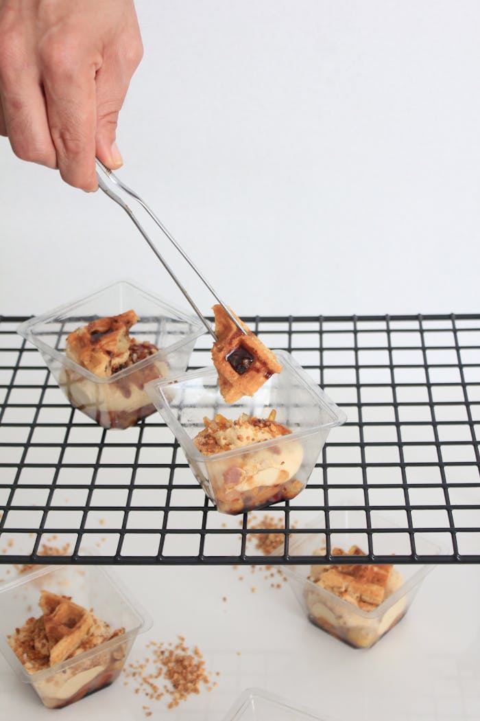 Delicious gourmet parfait being placed on a cooling rack, showcasing food presentation.